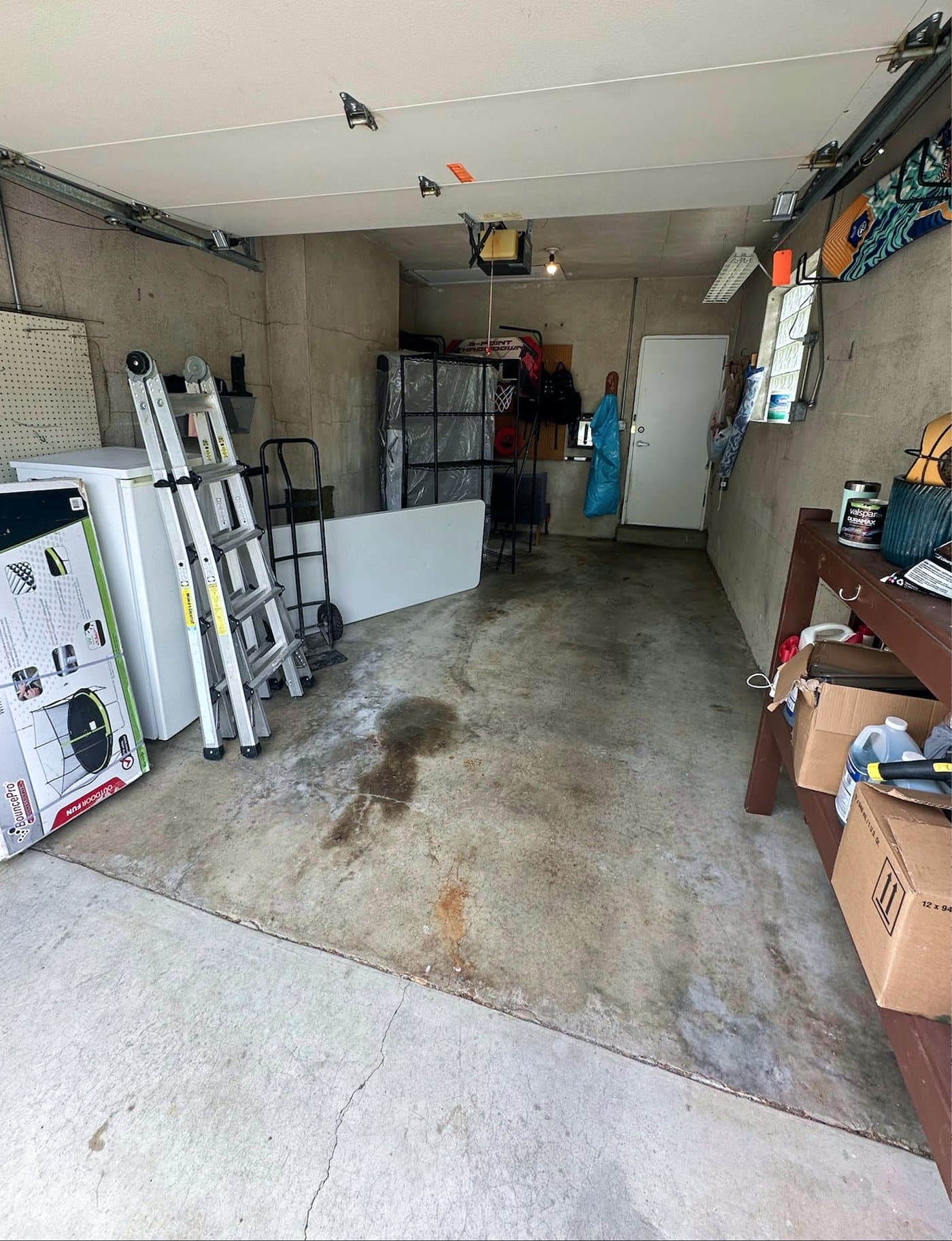 Before: bare stained concrete garage floor